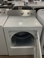Front-loading Maytag Centennial washing machine with door open in a showroom display.