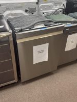 Row of stainless steel dishwashers on display in an appliance store, with sale price sign reading $630.00.