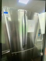 Stainless steel double door fridge with missing handle and a price tag reading $1,095 on the right door panel