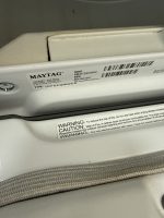 Close-up of a Maytag appliance data tag showing model MED7230HWO and serial MX2841951 with a barcode