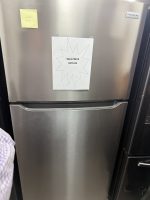 Stainless steel Frigidaire refrigerator with a bottom freezer drawer and a sale sign reading 'Sale Price $375.00' taped to the front; a yellow sticky note in the upper left corner.