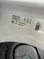 Close-up of a Maytag washing machine drum interior with a white label showing model MVWB835DW4 and electrical specs (8.0 amps, 120 volts, 60 Hz) on the door frame.