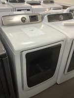 White Samsung front-loading washing machines on display in a showroom, with a sale placard on the closest unit.