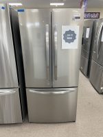 Stainless steel French-door refrigerator with a bottom freezer drawer on display; sale sign shows $950.