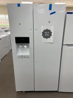 White side-by-side refrigerator with built-in water dispenser, displayed in a showroom; sale sign shows $775.