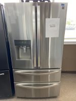 Stainless steel French-door refrigerator with a built-in water dispenser on the left and two bottom drawers; sale price $850 posted on the right door.