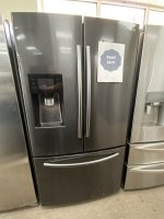 Samsung 4-door French-door refrigerator with bottom freezer on display; sale sign reads $475 attached to front door.