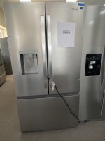 Stainless steel side-by-side refrigerator with a built-in water dispenser and a sales price sign reading $1495 on the right door.