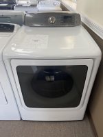 Front-loading Samsung washing machine in a showroom with a starburst sale sign reading 'SALE PRICE $250' on the top.