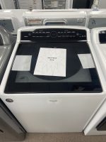 White Whirlpool Cabrio top-loading washer in a showroom with a starburst sale sign reading 'SALE PRICE $375' on the lid.