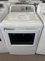 White front-loading washing machine on display with a sale price sheet on top.