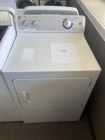 Top-loading white washing machine with a price-sign starburst reading 'SALE PRICE $195' placed on its lid surface.