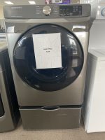 Front-loading Samsung washing machine with a starburst sale sign on the door reading 'SALE PRICE $350' taped to it.