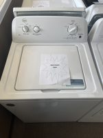 White top-loading washing machine with a starburst sale sign on the lid reading 'SALE PRICE $295'