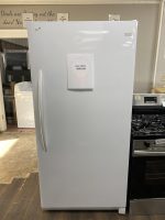 Frigidaire refrigerator in a showroom with a sale price sign reading $650 attached to the door.