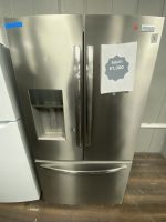 Stainless steel French‑door fridge with water dispenser on the left; a sale sign reads ‘Sale!!! $1,300’ on the right door.