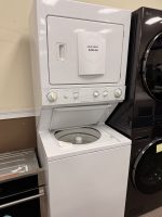 White stacked washer and dryer with a sale price sign reading $495 attached to the dryer door