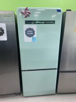 Mint-green vintage refrigerator with a paper sale sign reading 'Sale!! $1,800' and a decorative flower magnet.-Photo shows a retro fridge on display with price tag and blue sticky note at top right-