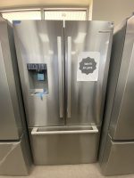 Stainless steel side-by-side refrigerator with water dispenser on the left; sale sign on the right door says “Sale!!! $1,875.”