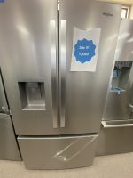 Stainless steel Whirlpool side-by-side refrigerator with a blue sale sign reading 'Sale!!! 1,550' taped to the right door and a water dispenser on the left door edge.