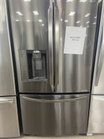 Stainless steel LG French-door refrigerator with water/ice dispenser on the left; a sale price note is taped to the right door reading 'SALE PRICE $695.00'.
