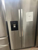 Stainless steel Whirlpool refrigerator with a right-door starburst sale sign reading 'SALE PRICE $350' taped on.