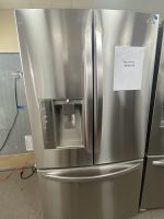 LG stainless steel French-door refrigerator with a built-in water dispenser on the left door, sale price tag showing $650.00 on the right door.