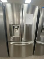 LG stainless steel French-door refrigerator with water/ice dispenser; sale price sign on right door reads $550.00 with a starburst graphic.