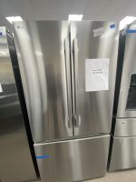 Stainless-steel French-door refrigerator in a showroom with a sale price tag reading $1150 attached to the right door.