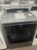 Front-loading Whirlpool washer on display in a showroom; a sale price sign shows $350.00 on top.