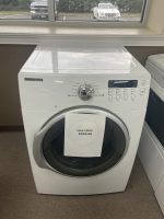 img_5137 - Discount Appliances Front view of a white Samsung washing machine in a showroom, with a sale price tag hanging over the door: $225.00