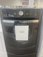 img_5145 - Discount Appliances Front view of a dark Maytag Maxima XL dryer with a chrome handle and a sale price sign reading $250.00 on the door.