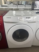 img_5292 - Discount Appliances White Samsung front-loading washing machine on a showroom floor with other appliances in the background.