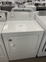 White top-loading washing machine in a showroom with a sale label reading $275.00 on the lid and a Push to Start button nearby.