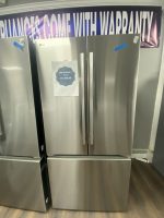 LG stainless steel side-by-side refrigerator with two vertical handles; sale tag on left door showing $1,150.00