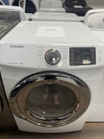 Samsung front-load washing machine with a large circular door and control panel on the right; sale label on top.