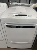 Front view of a white LG top-loading washing machine with a sale price sign on the lid (shows $275.00).