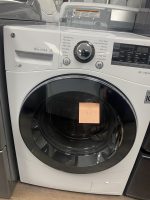 Front-loading LG washing machine with a large central dial and control panel displaying wash settings and a digital screen on the right.