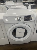 Front-loading Samsung washing machine on display with a sale price tag of $295.00 on the door.