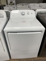 White top-load washing machine on display with a sale-price tag reading $275.00, surrounded by other laundry appliances in a showroom.