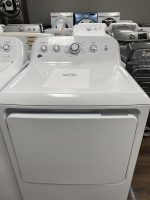 White front-loading washing machine on showroom floor with sale price sheet reading $295.00 on top of the drum area.