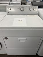 White top-load washing machine on display with a sale price sign showing $250.