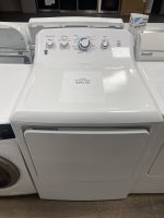 img_9094-3 - Discount Appliances White top-load washing machine with control panel visible and a sale price tag on the lid reading $295.00 in blue text.