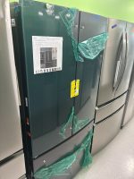 48308b48-4f8e-4009-9a26-6f6a979dec2b-4829-0000021a6eaa0364_file - Discount Appliances Green French-door refrigerator on display, with torn green plastic wrap and various labels taped to the door
