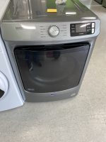 9554f4a0-f091-4c84-ae34-657968159c56-34367-000004077a76408a_file - Discount Appliances Front view of a Maytag front-loading washing machine with a large central control dial and display panel on the right.