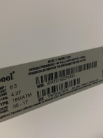 Close-up of a Whirlpool label on a white appliance showing electrical specs (60 Hz, 1 phase, 115V), design/service pressure (140 psi / 330 psi), model WRT518SZFM00, serial VS72347974, and a barcode.