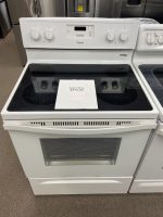 White Whirlpool electric range on display with a sale sign reading 'SALE PRICE $375.00' on the stove top