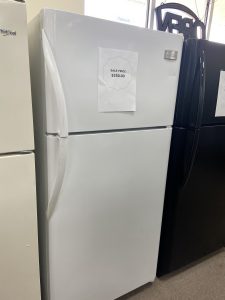 White refrigerator in a store with a paper sale price sign reading 'SALE PRICE $250.00' on the door.