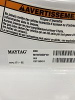 Close-up of a Maytag appliance warning label in French, with an orange AVERTISSEMENT bar and a fire risk notice.